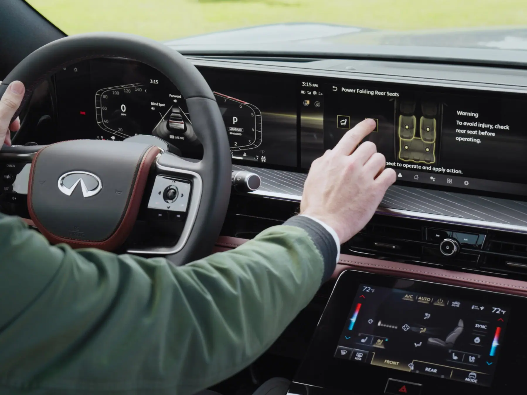 Driver using the dual screen infotainment in the 2026 INFINITI QX80