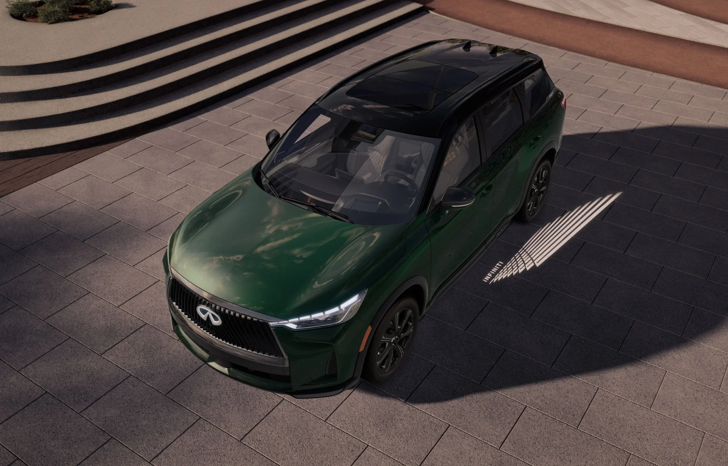 2027 INFINITI QX60 exterior front three-quarter view in driving shot